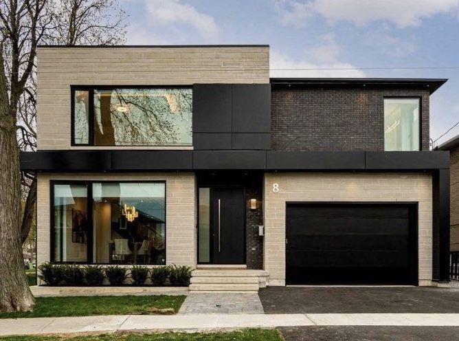 Tan house with black trim and glass windows