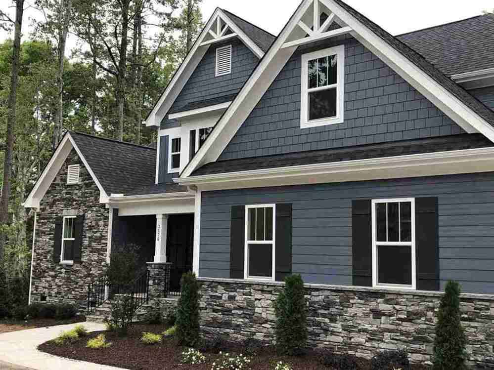 Blue house with white windows and gable roof