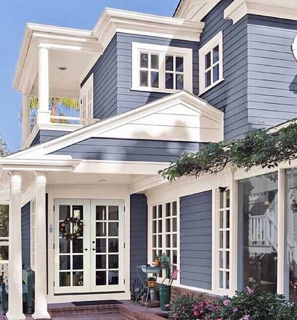 Blue house with white trim and windows and white door