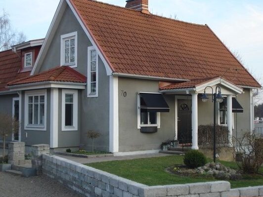 Grey house with brown roof and white white