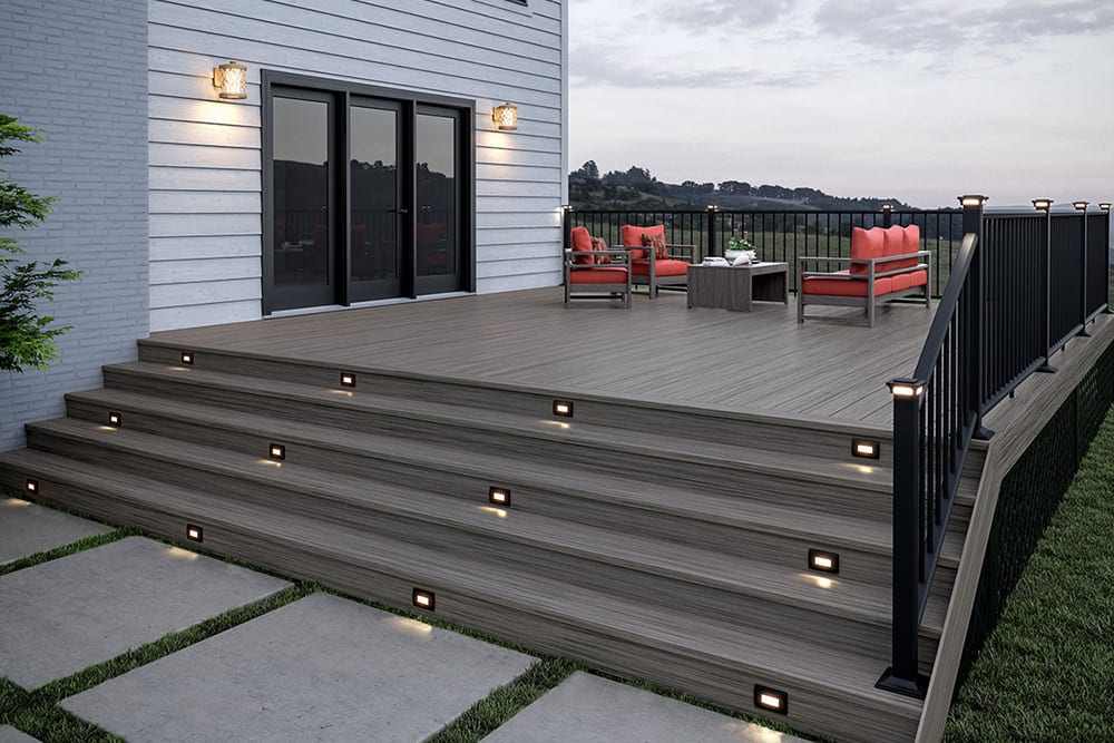 Cedar staircase with black railing and lights on the wall and sofa outside of the house