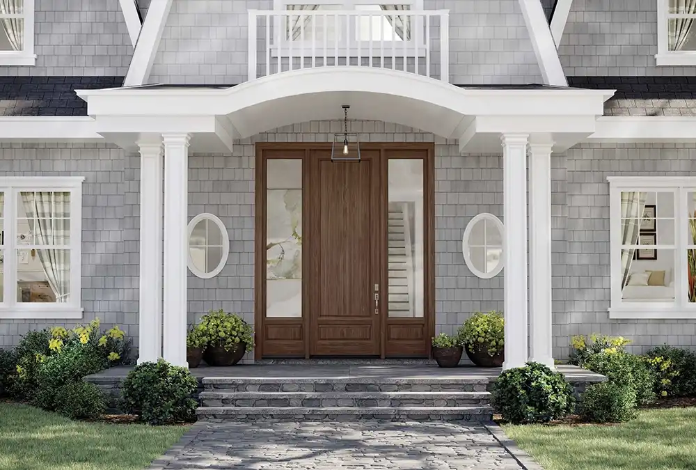 Wooden gate on light grey house and light above the wall