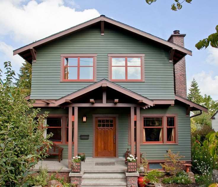 A brown trim on green house and glass window and wooden door
