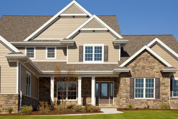Tan house with white trim brown shutter