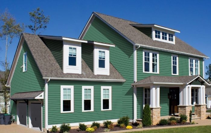 Dark green house with windows and roof