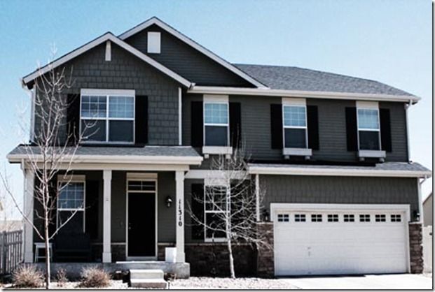 Dark grey house with black shutters and white trim 