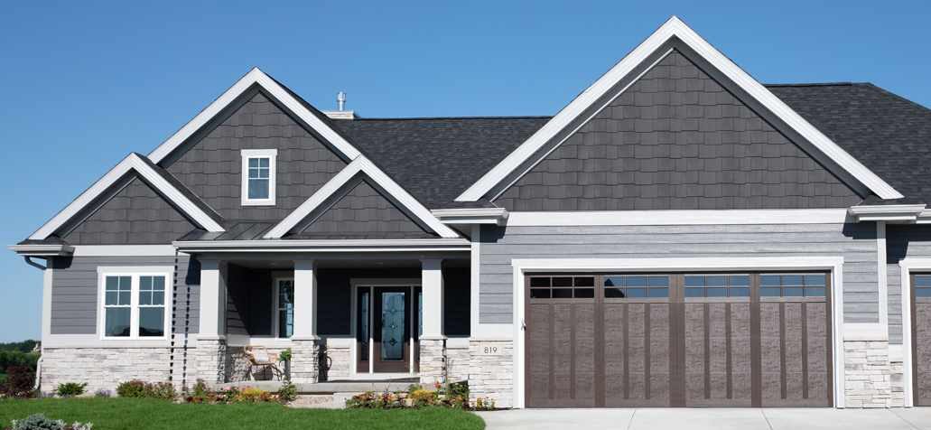 dark grey shingles on light house and white trim and black glass door 