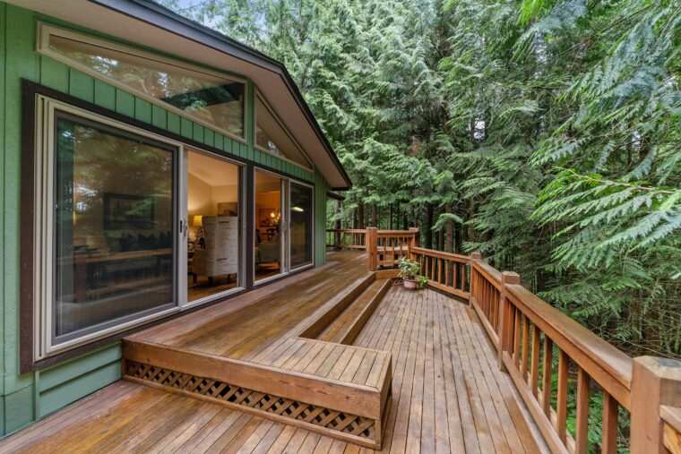 Wooden porch and green house glass windows and warm lights