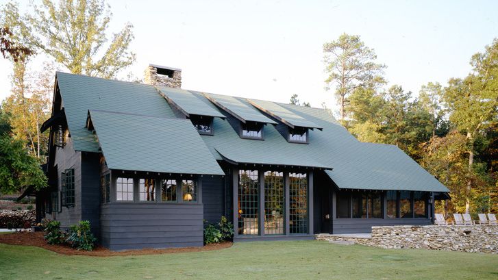 Green house on black house and glass window and garden outside of the house