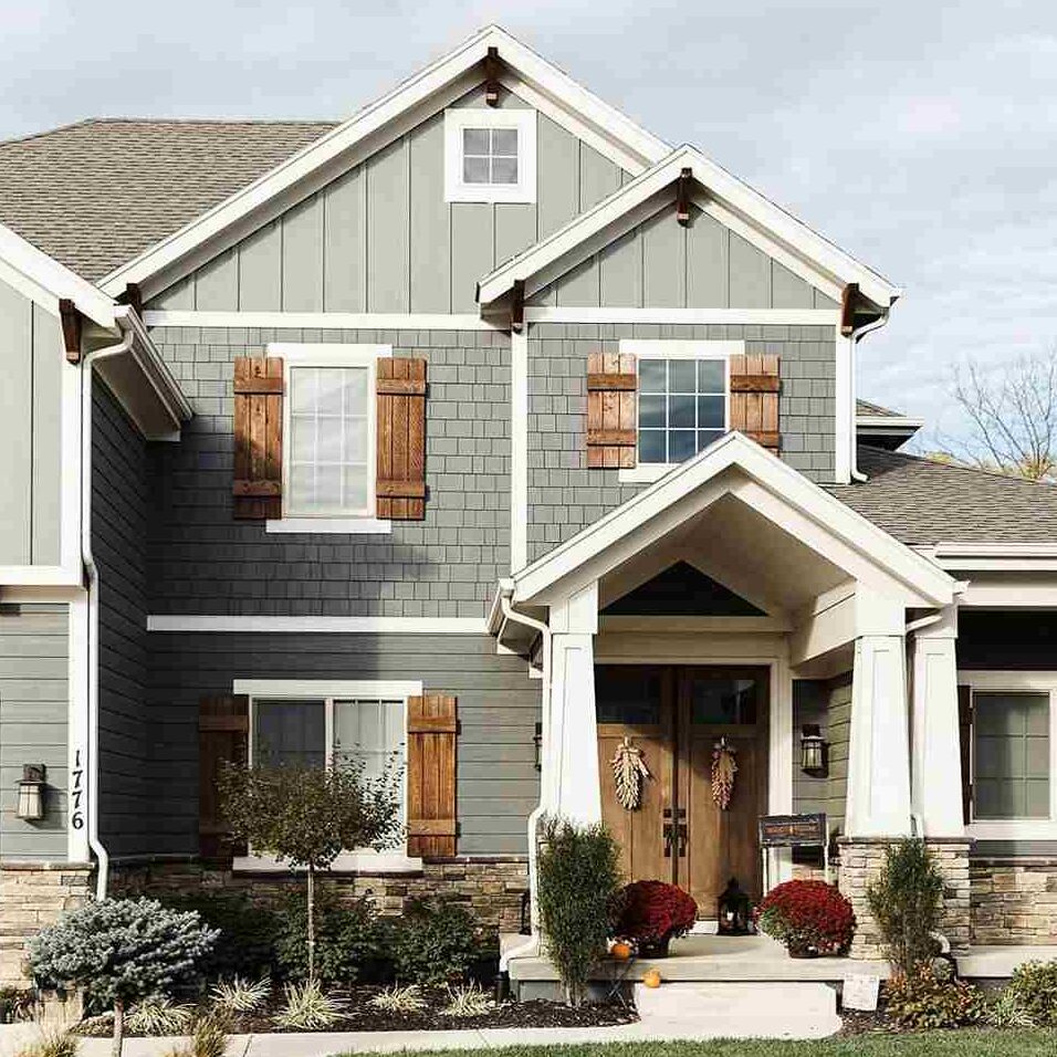 Grey brick house with wooden shutter and wooden door