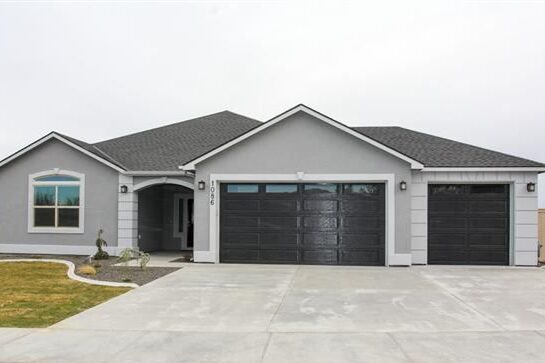 Light grey house with black garage door and white trim windows