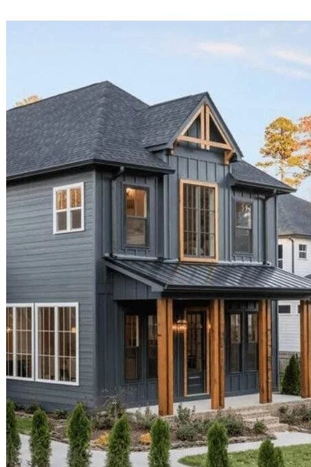 A dark grey house with black roof and windows 