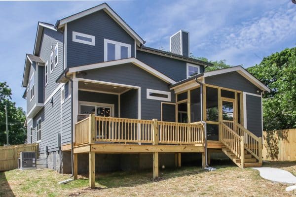 Grey house with cedar balcony and white trim