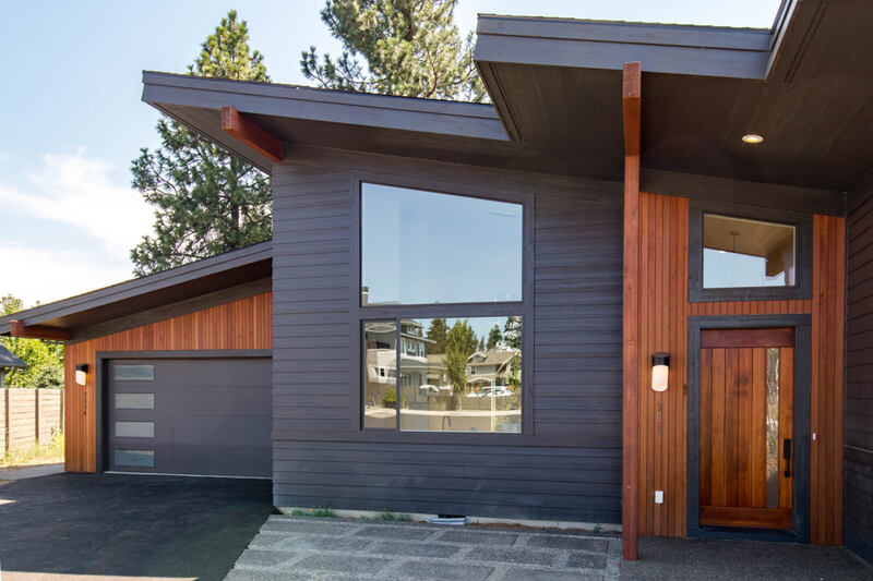 Grey house with cedar sidling and light on the wall