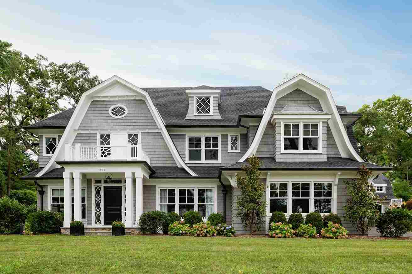 Grey house with white windows and garden outside of the house