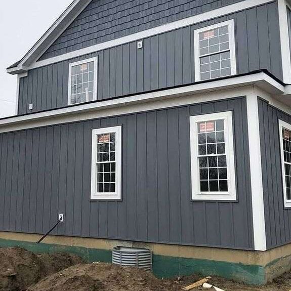 Light grey house with board and batten and white framed windows