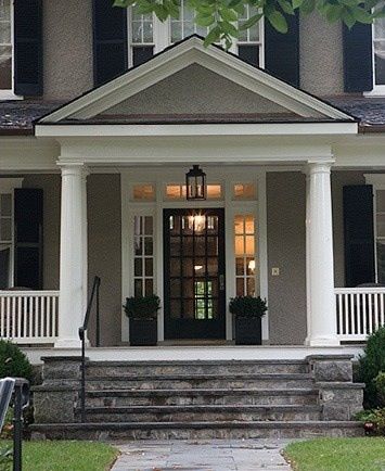 White pillars on grey house and lights and black glass door
