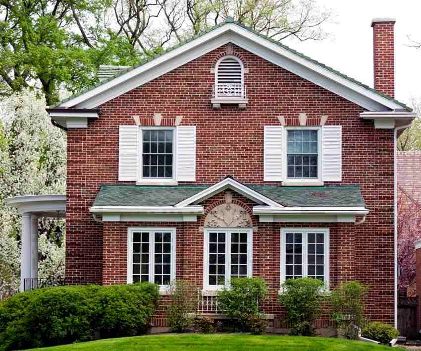 A red brick house and white trim windows