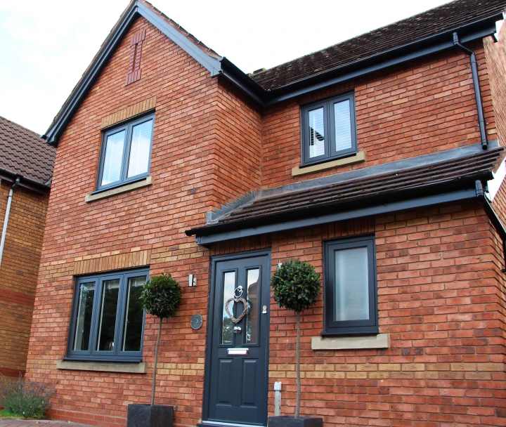 Red brick house with black windows and black door