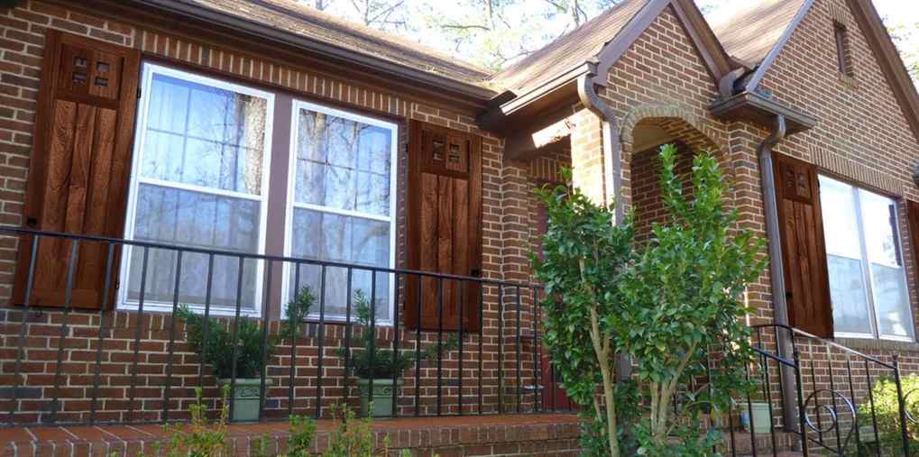 Red brick house with wooden and glass windows