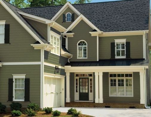 Sage green house with black shutter and white windows