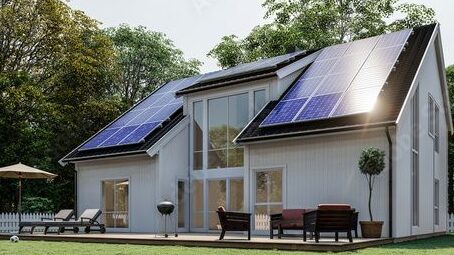 Black roof with solar panels an white house