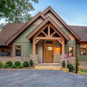 Green house with stone based and wooden gable roof and a stone pathway