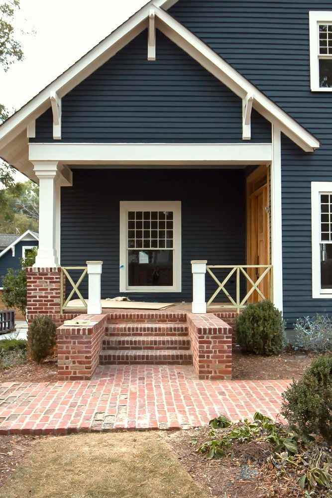 Stone pathway on blue house and white trim