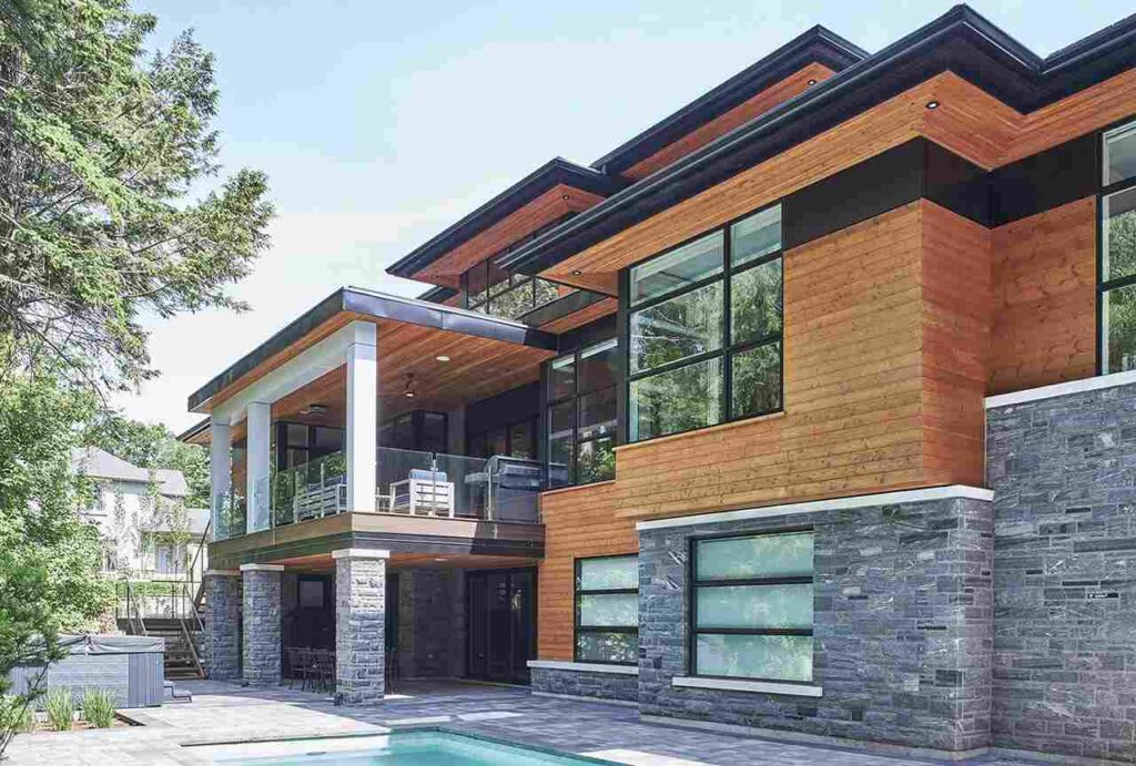 Stone base  with wooden house with black trim 