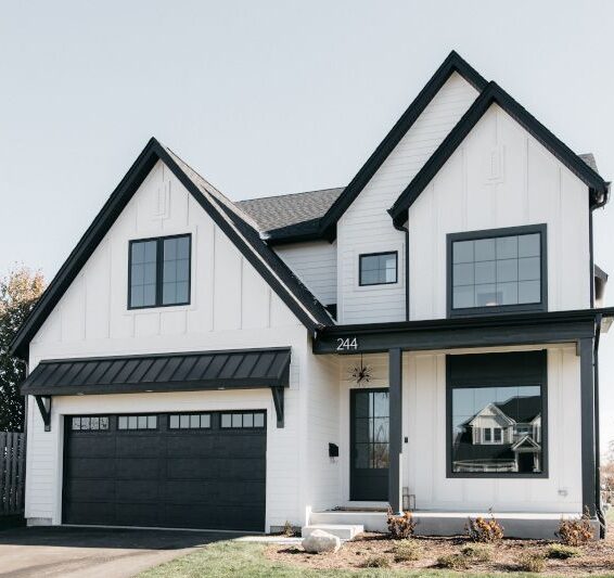 White house with black trim and black framed windows and door 