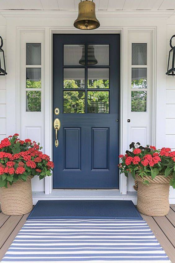 white house with glass blue door and flower pot outside of the house