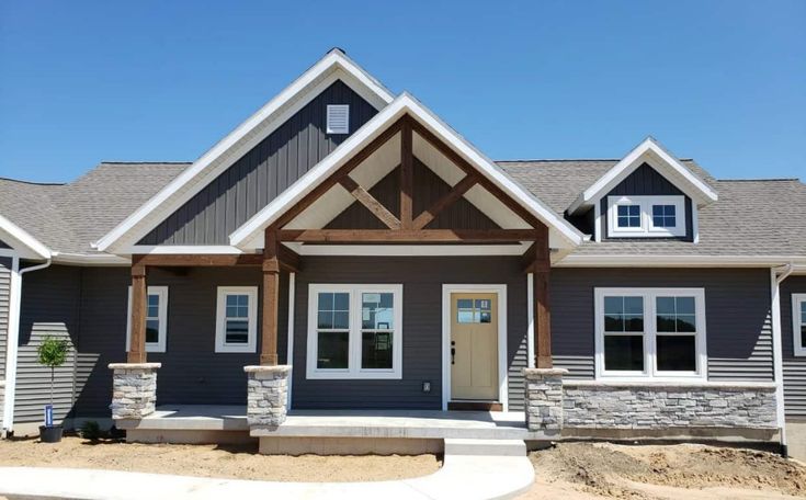 Grey house with wooden accent and white trim windows