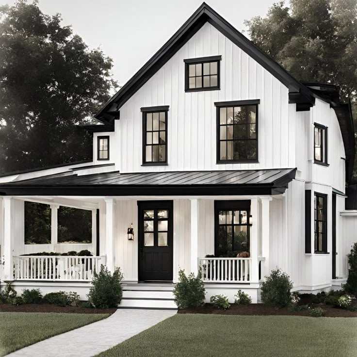 A white house with black framed windows and black front door and celling light on the wall
