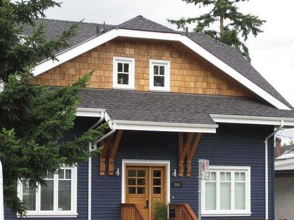 Wood and panels on blue house and white trim windows