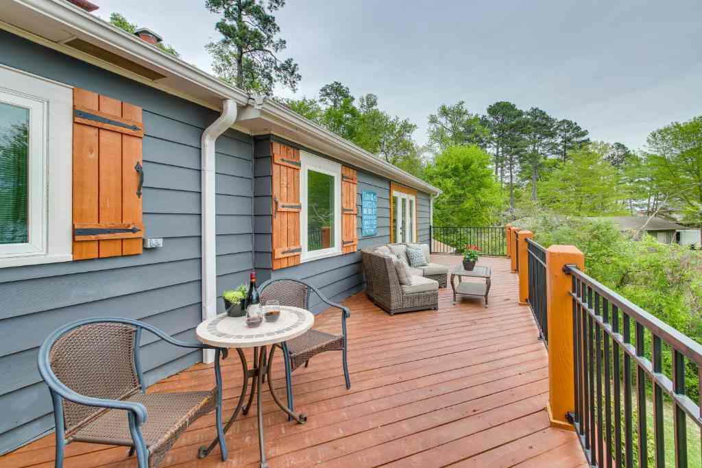 Wooden decking o grey house and chair outside of the house
