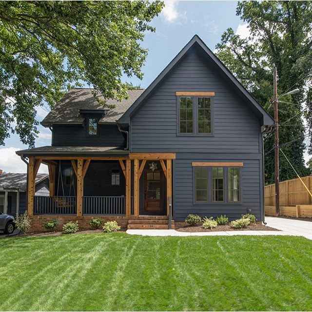 Grey house with wooden accents and garden outside of the house