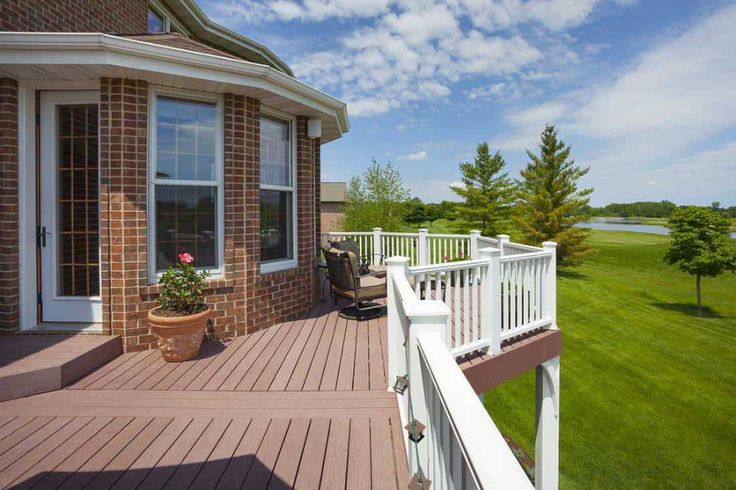 wooden porch on red house with white balcony