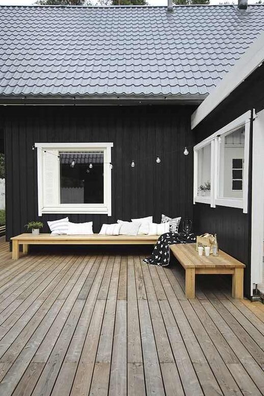 Wooden porch and white cushion put on sofa and white trim windows