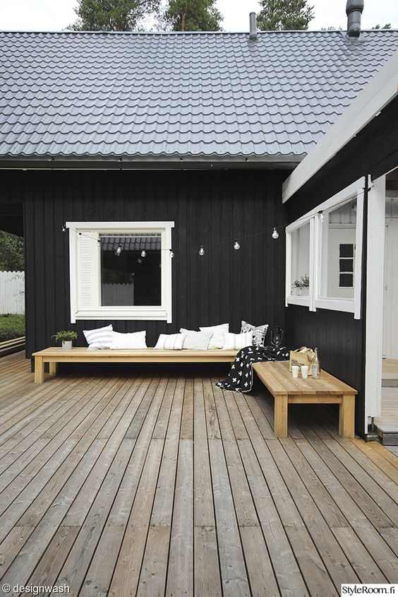 Wooden porch and white cushion put on sofa and white trim windows