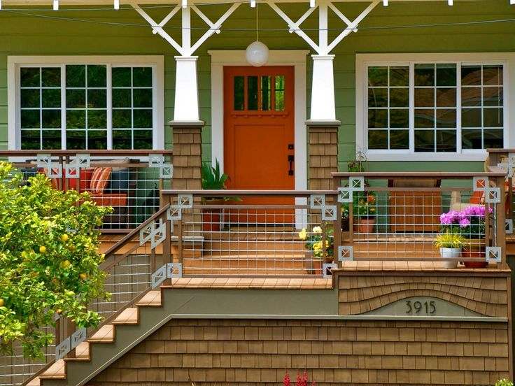 Wooden staircase with red front door and white windows