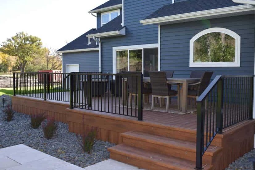 wooden stairs and railing on blue house