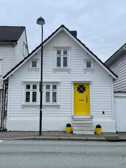 White house with yellow door and white windows