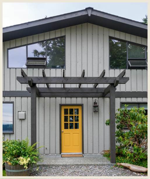 Yellow door on grey house with black trim
