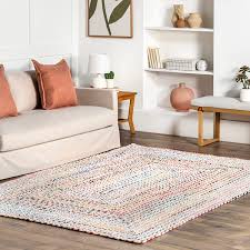 A woven rug on wooden floor