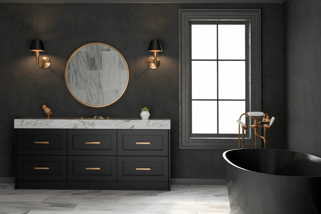 A black bathroom with gold lamp and fixture and black bathtub