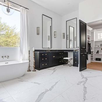 Black door in charcoal grey and white bathroom and white marble floor 