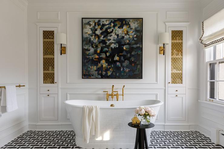A white bathroom with bathtub and gold accents