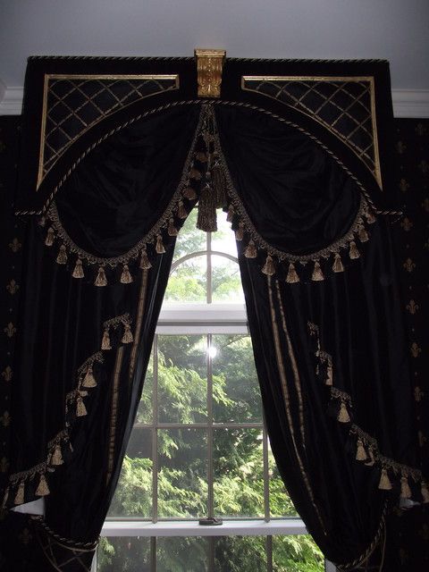 A black curtains with gold rods