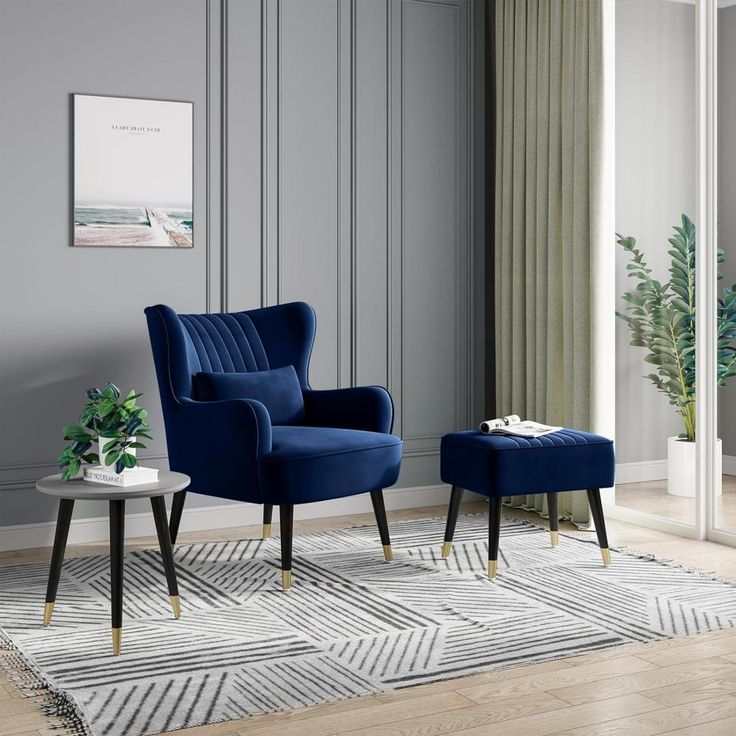 A living room with blue chair and rig on the wooden floor 