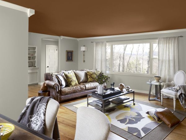 A brown celling with light grey room with a table and mat on the floor